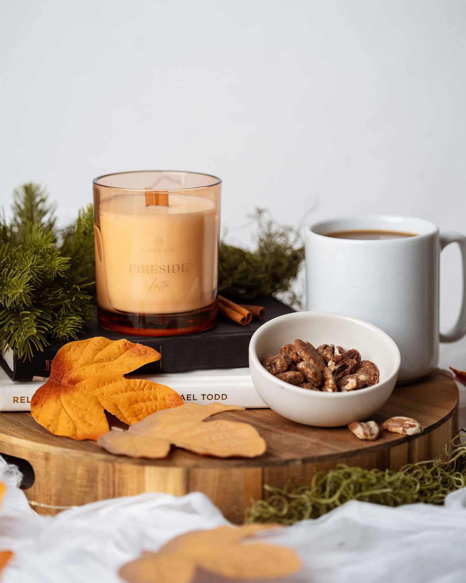 Fireside Latte Candle with a cup of coffee and a bowl of sugared pecans